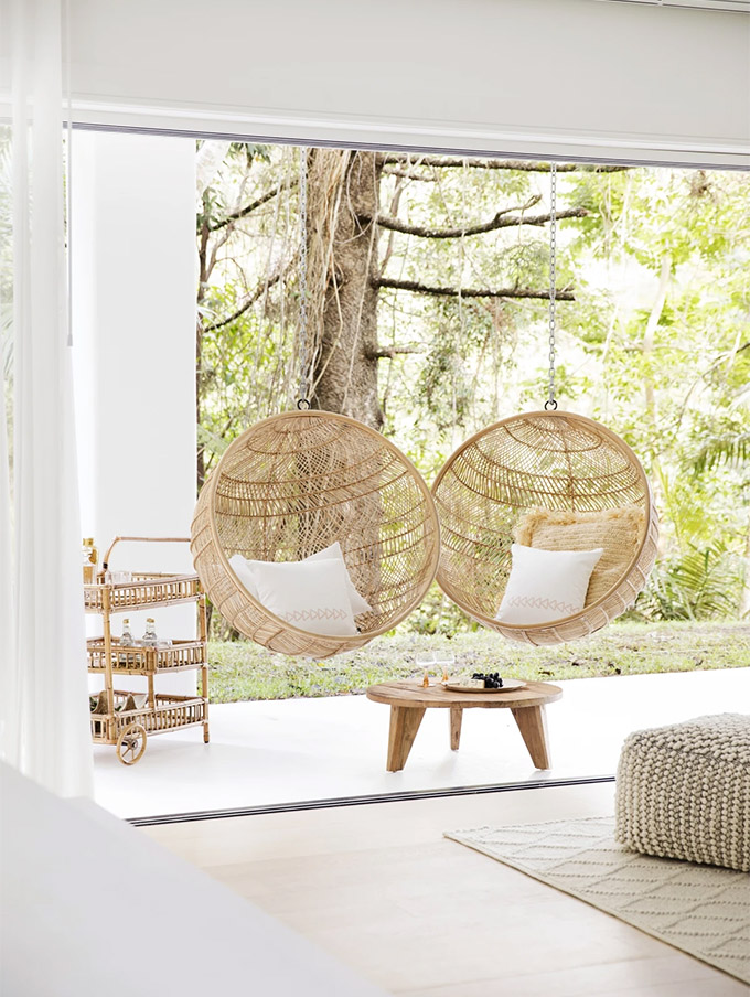 hanging swing chairs on a beautiful updated patio