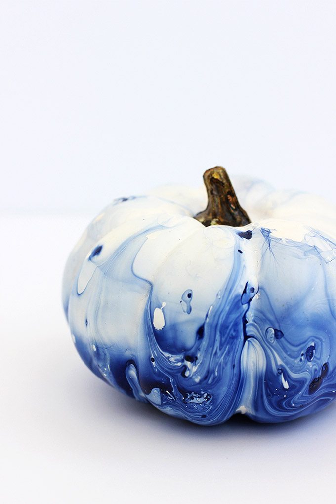 A white pumpkin with a swirly blue marbled pattern