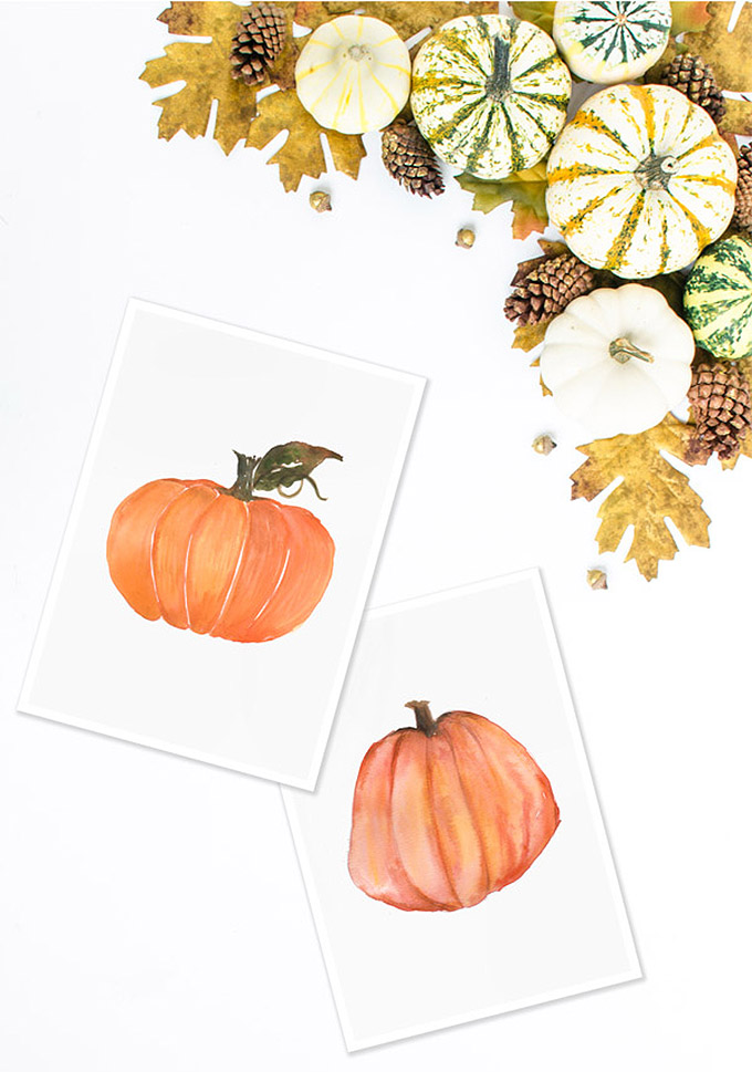 Orange watercolor pumpkins painted on two white cards.
