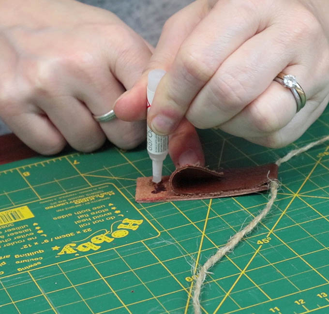 Glueing the leather tab in order to hang my DIY wall hanging - this step is optional in this project!