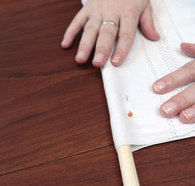 Pin the fabric of your wall hanging so it's easier to stitch it into place