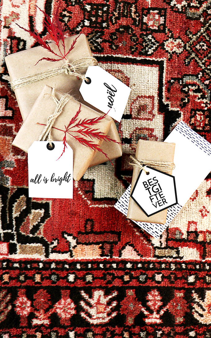 Black and white Free Printable Christmas Gift Tags, clean scandinavian style gift tags set on a Persian rug backdrop