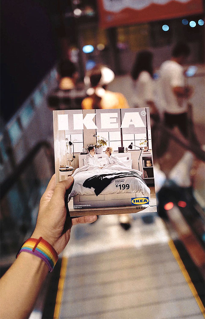 A man holding an IKEA catalogue