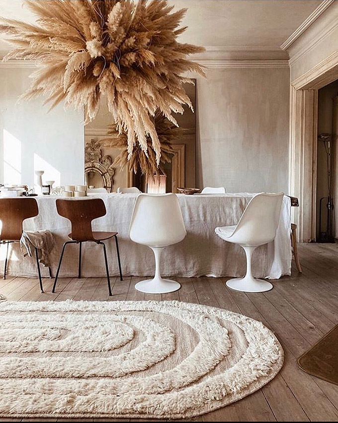 taupe pampas cloud hanging above a dining table, neutral tones