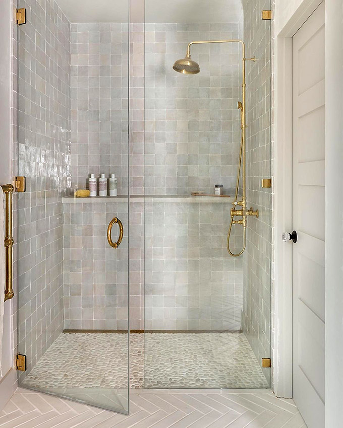 pretty gold shower head in a tiled bathroom