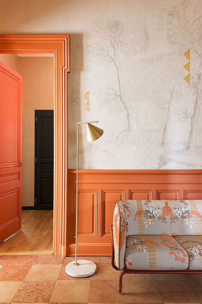 vibrant room painted salmon orange with intricate molding