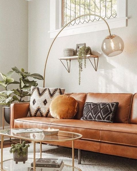 eclectic throw pillow combo on a camel colored leather sofa