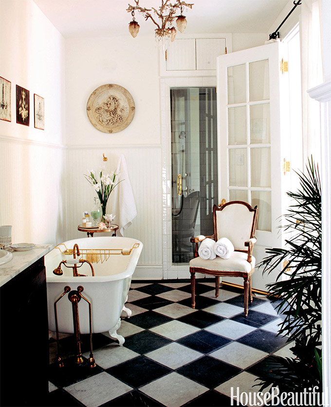 black and white checker tile traditional bathroom with clawfoot tub and antique chair