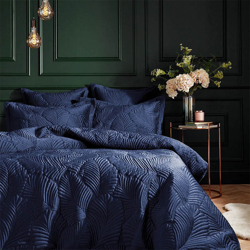 green walls paired with deep blue bedding