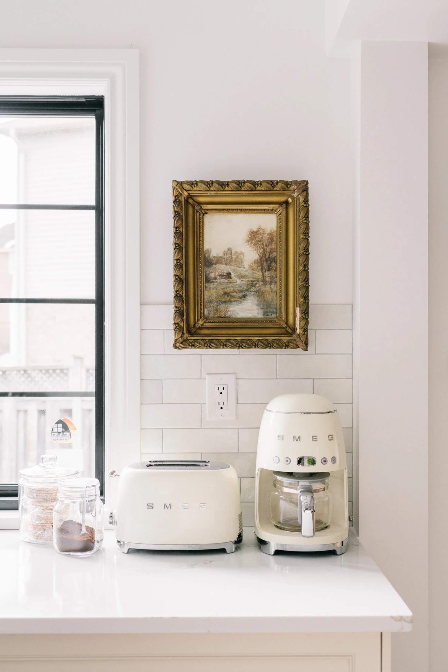 white smeg appliances in white kitchen with white subway tile