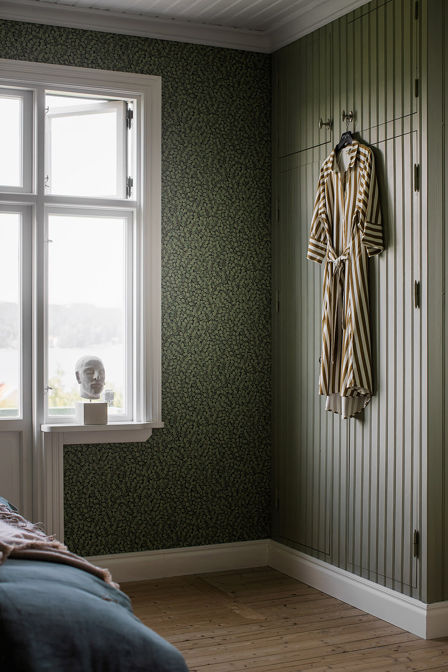 muted green patterned wallpaper in bedroom