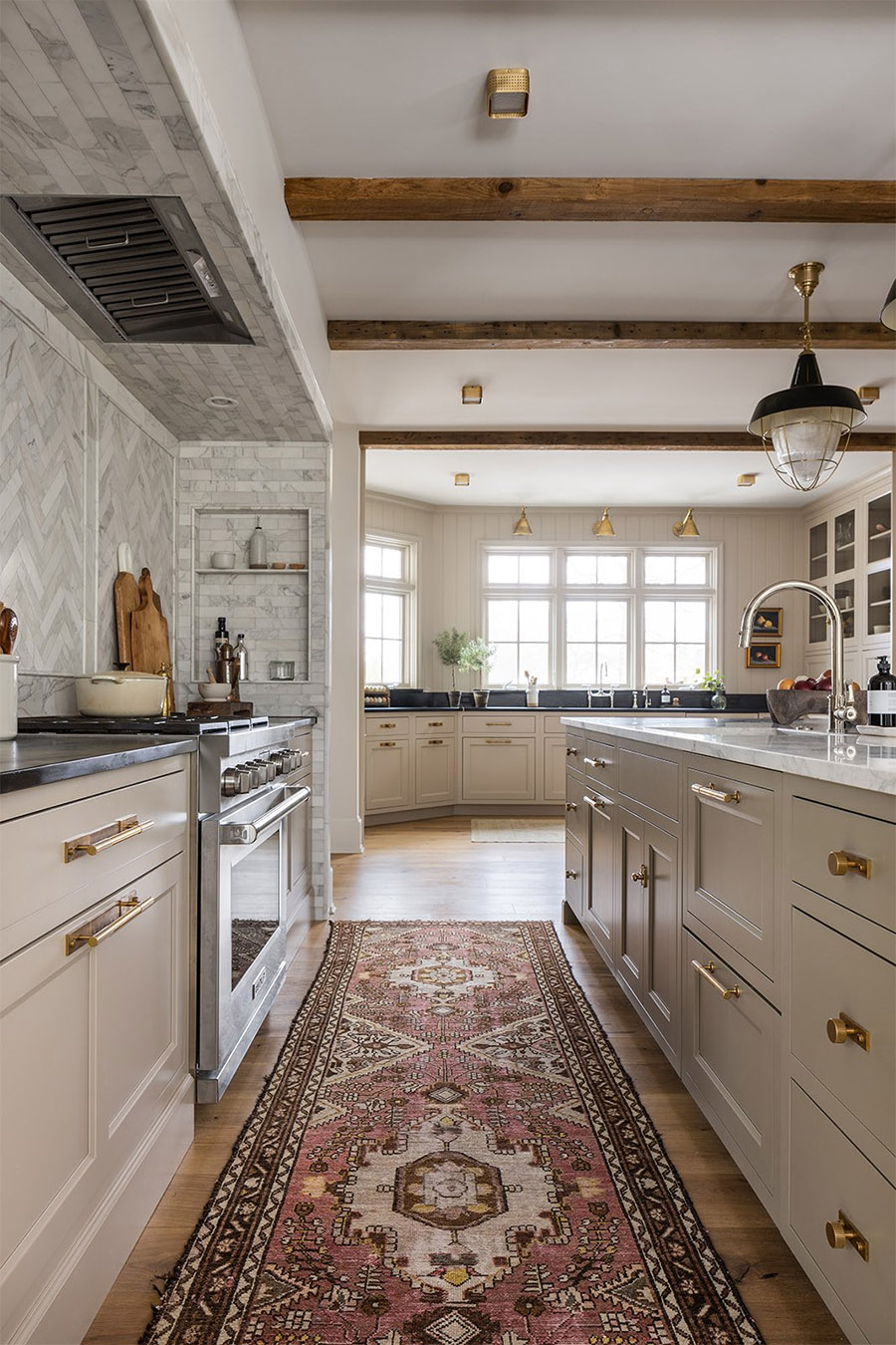 transitional kitchen using mixed metals on cabinet hardware, faucets and lighting