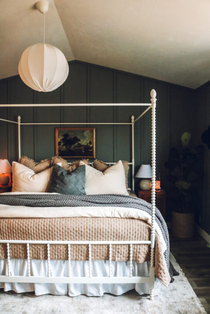 moody green bedroom with white four poster bed