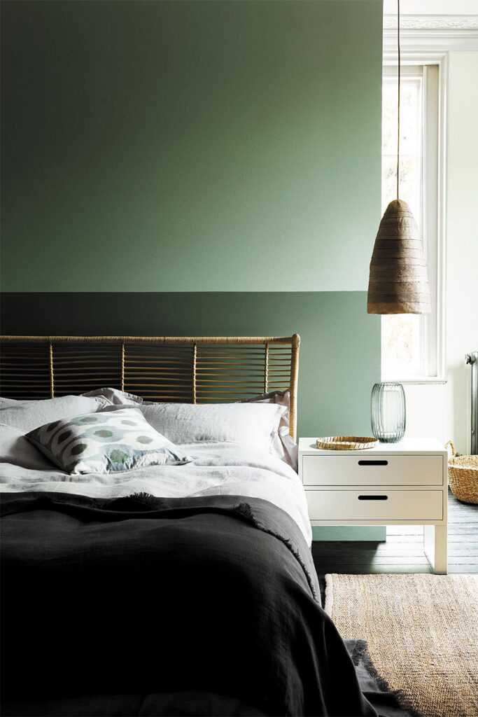 two tone green bedroom with hanging woven pendant