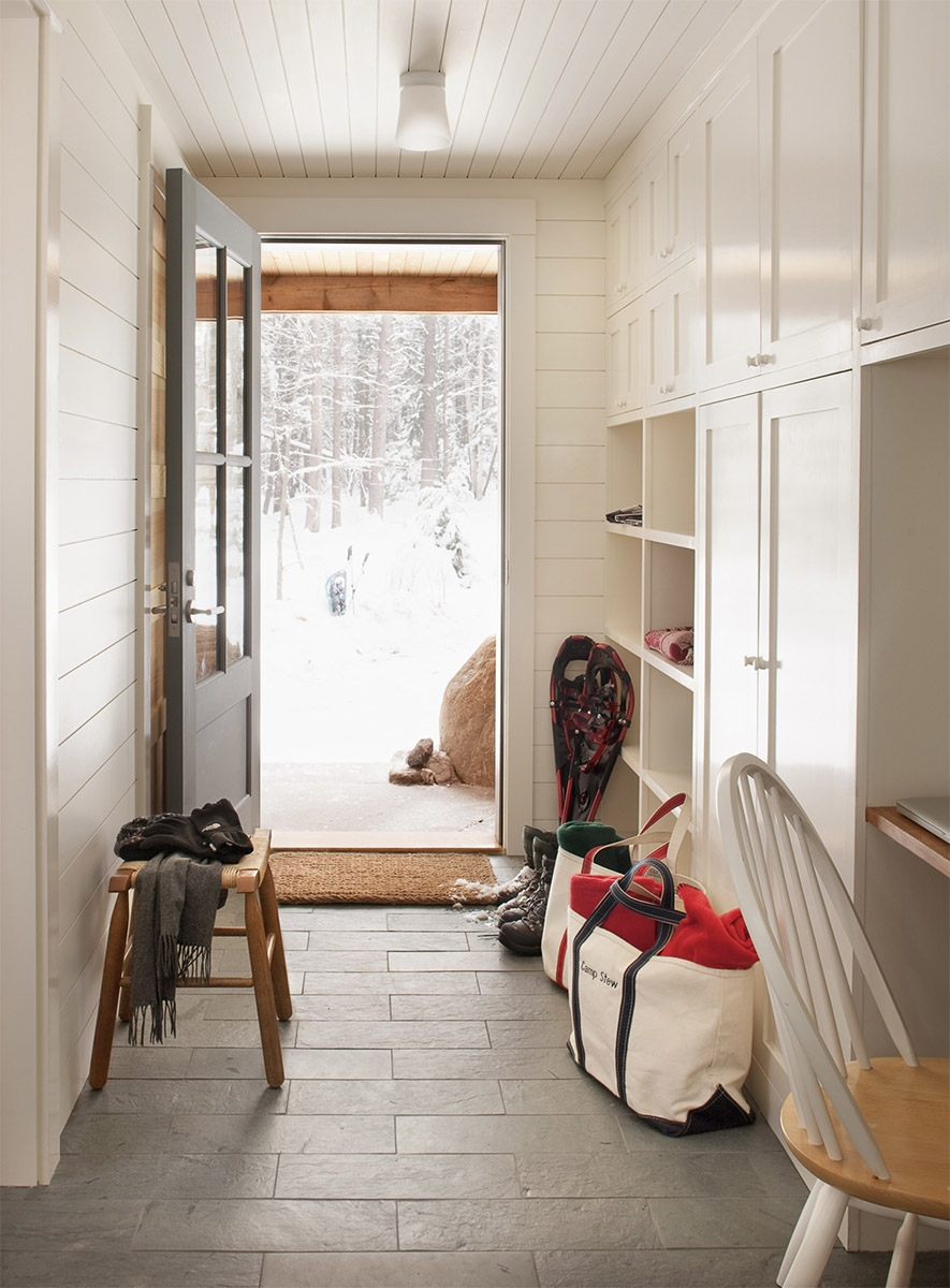 mudroom painted in swiss coffee, built in cabinetry and ship on the walls and  ceiling