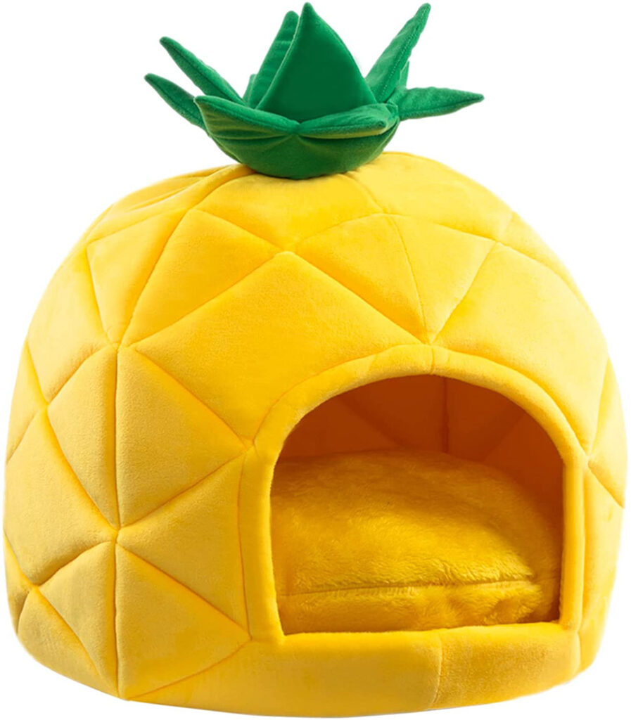 plush yellow pineapple dog bed with green plush leaves