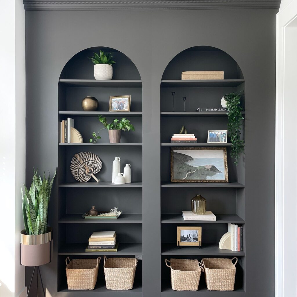 Dark gray built-in billy bookcases with arched fronts