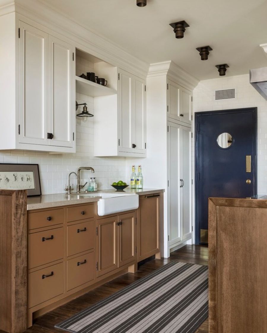 benjamin moore swiss coffee painted kitchen cabinets with tan and navy accents and a farm house sink