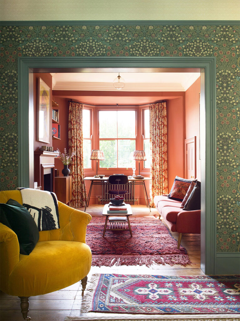 victorian home featuring william morris wallpaper with green trim juxtaposed on a salmon sitting room