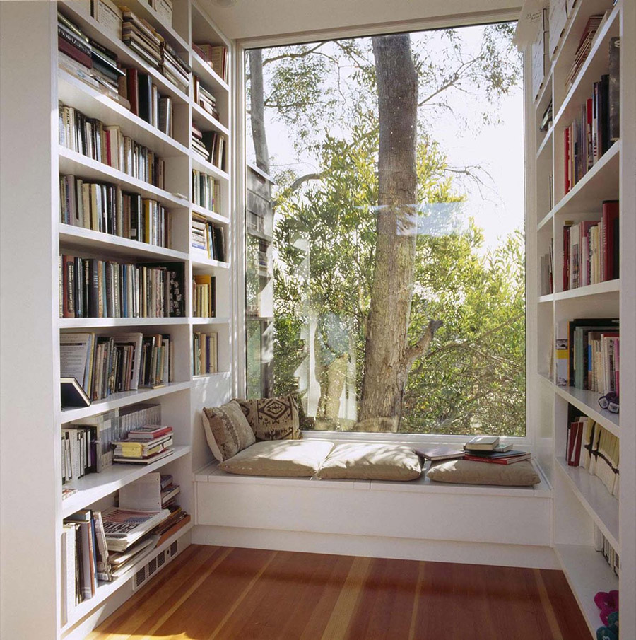 reading nook with bookshelves flanking either side of a window seat