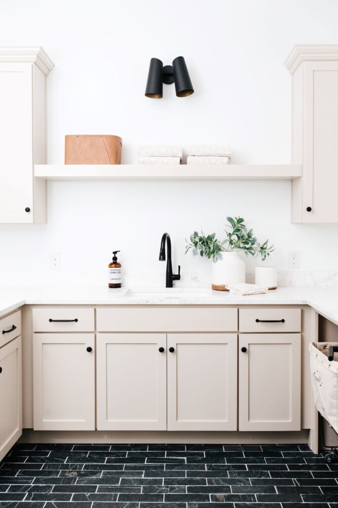 BM edgecomb gray washroom with black tile floor and dark cabinet hardware