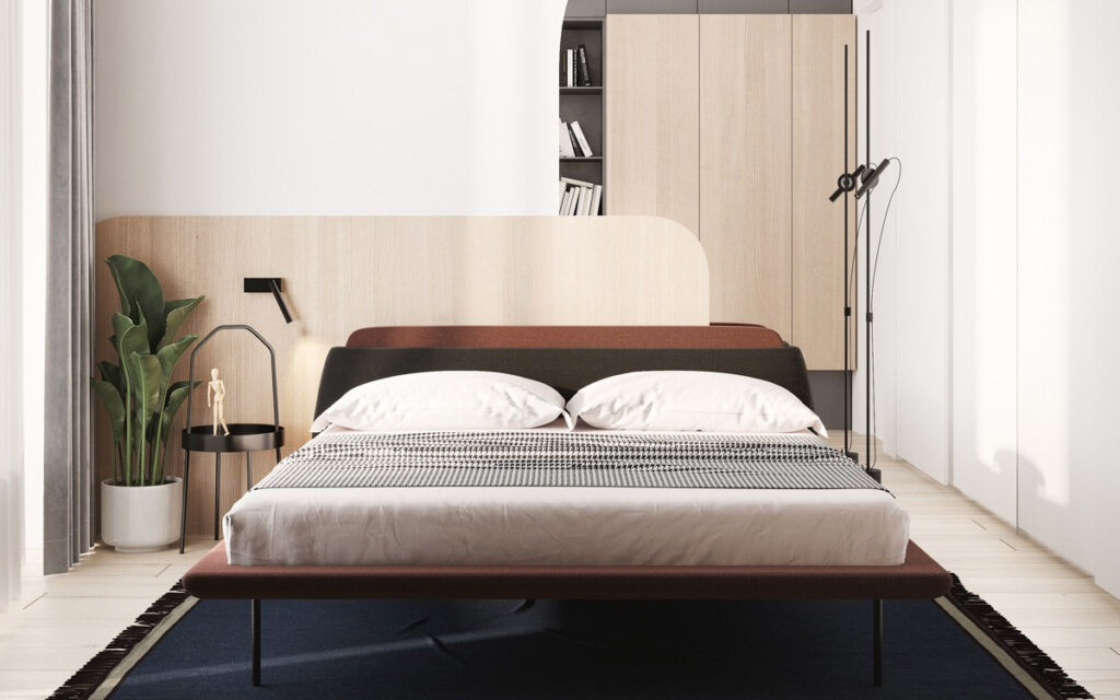 A contemporary bedroom with mismatched nightstands and/or light fixtures.